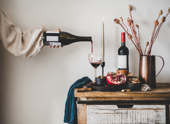 hand pouring glass of wine