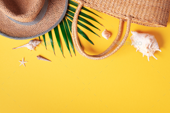 Summer fashion flat lay. Stylish straw bag, hat, palm leaves, shells on  trendy yellow background Stock Photo by jchizhe