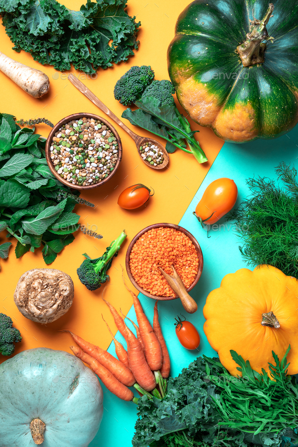 Organic vegetables, lentils, beans, raw ingredients for cooking on trendy yellow and green - Stock Photo - Images