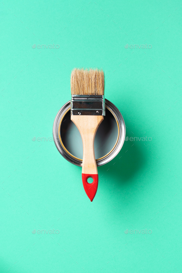 Paint brush and open paint can with on trendy green background. Top view, copy space. Appartment - Stock Photo - Images
