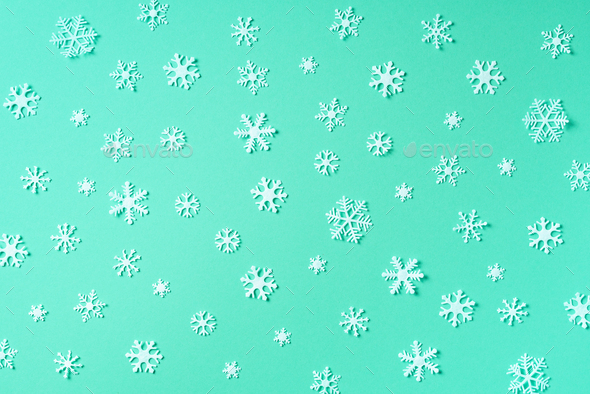 Winter pattern made of white snowflakes on trendy green background. Top view. Flat lay. Winter - Stock Photo - Images