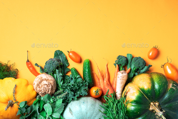 Autumn vegetables on trendy yellow background. Top view. Vegan and vegetarian diet, harvest concept - Stock Photo - Images
