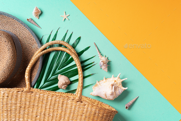 Summer fashion flat lay. Stylish straw bag, hat, palm leaves, shells on trendy yellow and green - Stock Photo - Images