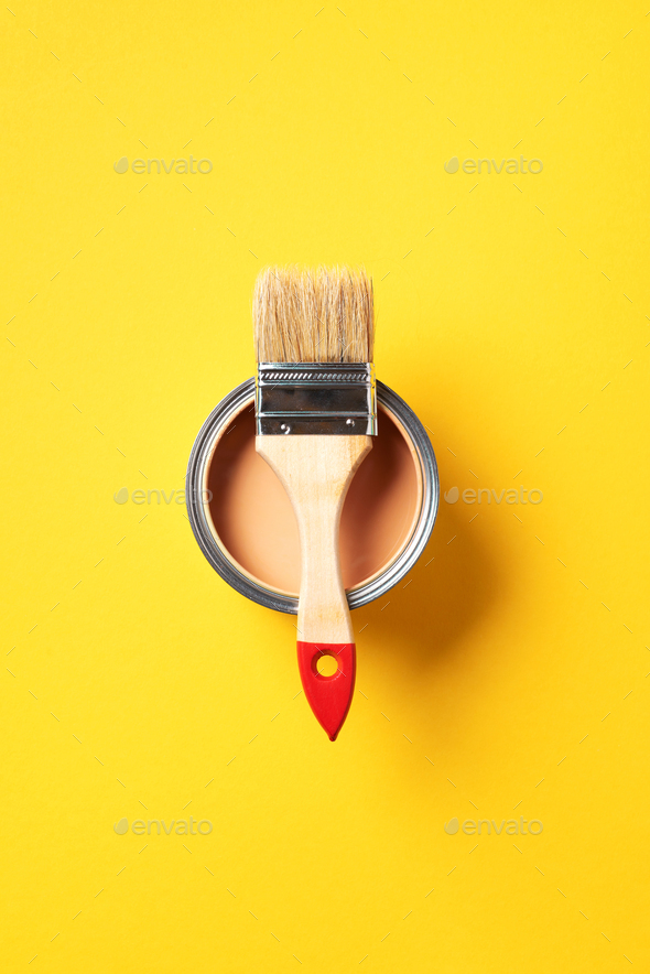 Brush and open paint can with on trendy yellow background. Top view, copy space. Appartment - Stock Photo - Images