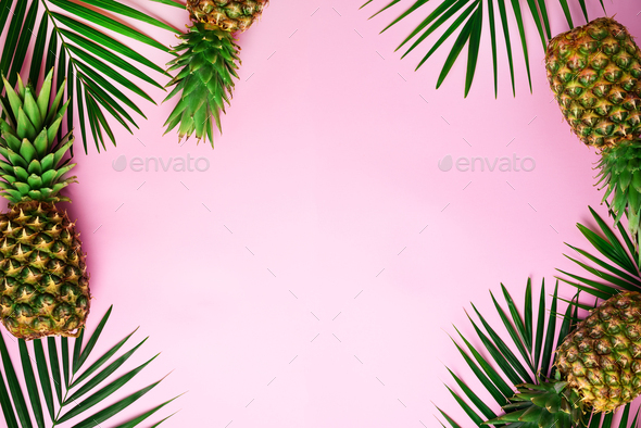 Pineapples and tropical palm leaves on punchy pastel pink background. Summer concept. Creative flat - Stock Photo - Images