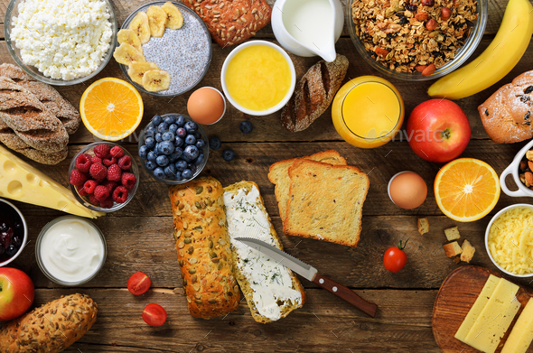 Female hands spreading butter on bread. Woman cooking breakfast. Healthy breakfast ingredients, food - Stock Photo - Images