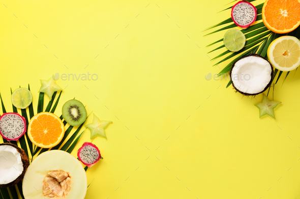 Exotic fruits and tropical palm leaves on pastel yellow background - papaya, mango, pineapple - Stock Photo - Images