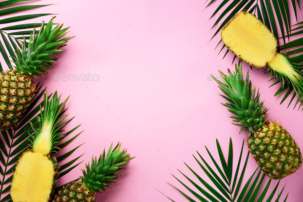 Half slice of fresh pineapple and whole fruit, palm leaves on yellow background. Top View. Copy - Stock Photo - Images