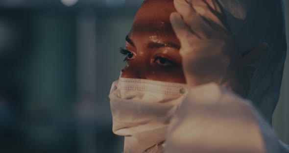 Sweaty Black Woman Taking of Hazmat Suit alt