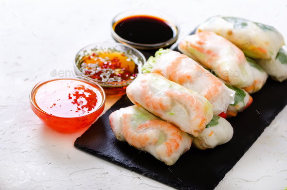 Vietnamese spring rolls - rice paper, lettuce, salad, vermicelli, noodles, shrimps, fish sauce - Stock Photo - Images