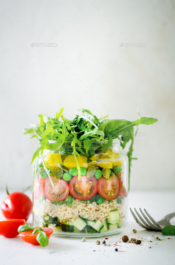 Healthy salad jar with quinoa and vegetables, cherry tomatoes, cucumber, ruccola. Raw vegetarian - Stock Photo - Images