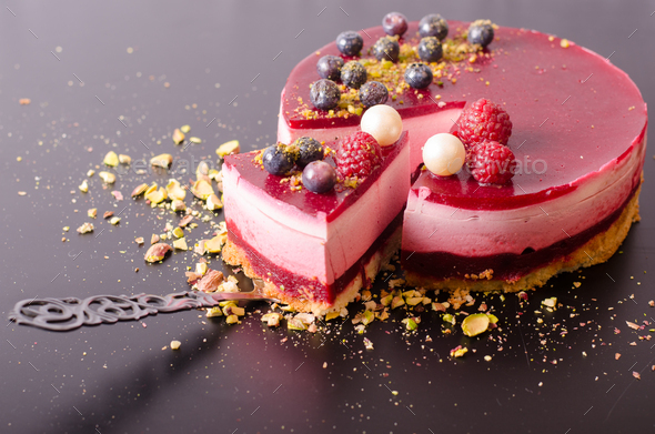 Piece of delicious raspberry cake with fresh strawberries, raspberries, blueberry, currants and - Stock Photo - Images