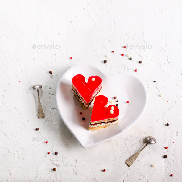 Two jelly heart-shaped cakes on white concrete background. Free space for your text