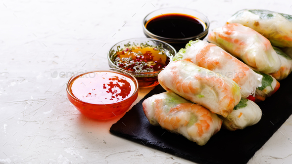 Vietnamese spring rolls - rice paper, lettuce, salad, vermicelli, noodles, shrimps, fish sauce - Stock Photo - Images