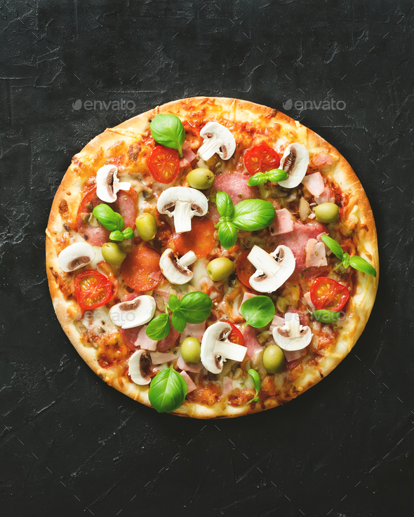 Fresh italian pizza with mushrooms, ham, tomatoes, cheese, olive, basil on black concrete background - Stock Photo - Images