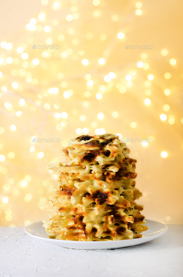 Traditional cake Shakotis, Sakotis on white plate, festive background, light new year and christmas - Stock Photo - Images