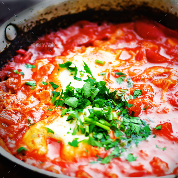 Shakshuka. Traditional jewish food and middle eastern cuisine recipe. Fried eggs, tomatoes, bell - Stock Photo - Images