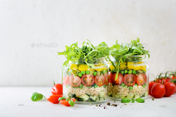 Healthy salad jar with quinoa and vegetables, cherry tomatoes, cucumber, ruccola. Raw vegetarian - Stock Photo - Images