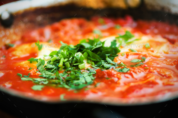 Shakshuka. Traditional jewish food and middle eastern cuisine recipe. Fried eggs, tomatoes, bell - Stock Photo - Images