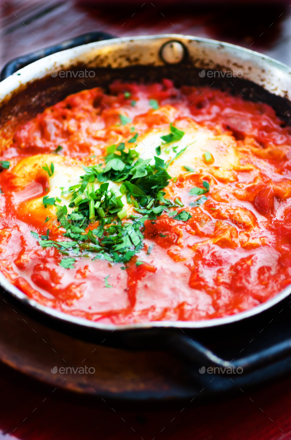 Shakshuka. Traditional jewish food and middle eastern cuisine recipe. Fried eggs, tomatoes, bell - Stock Photo - Images