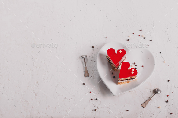 Two jelly heart-shaped cakes on white concrete background. Free space for your text. Toned effect