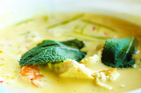 Spicy coconut milk cream soup curry with chiken, tiger prawns, long soy noodles, bean sprouts, lime - Stock Photo - Images