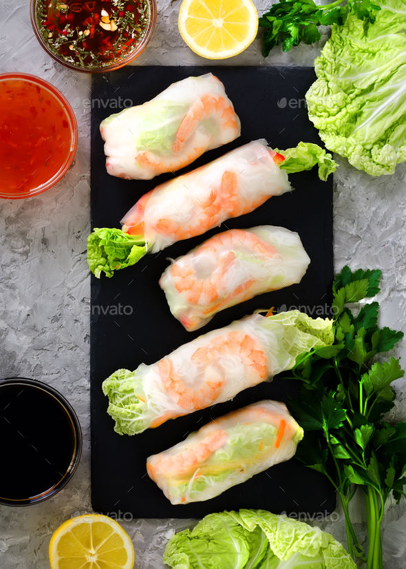 Fresh Vietnamese, Asian, Chinese food frame on grey concrete background. Spring rolls rice paper - Stock Photo - Images