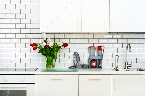 Fresh bouquet of red and white tulips on kitchen table. Detail of home interior, design - Stock Photo - Images