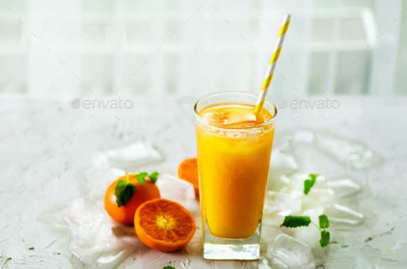Orange juice with ice and tangerines on white background. Free space for your text. Copyspace. Cold - Stock Photo - Images