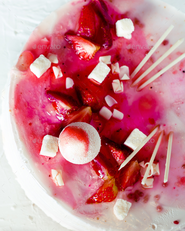 Summer strawberry mousse cake, fresh berries, coconut, and sweet decor element on top, white - Stock Photo - Images