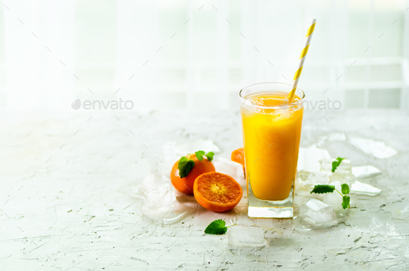 Orange juice with ice and tangerines on white background. Free space for your text. Copyspace. Cold - Stock Photo - Images