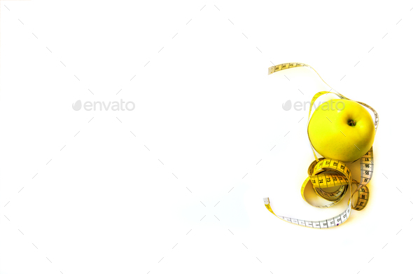 Measuring tape wrapped around fresh tasty yellow apple isolated on white background. Diet, weight - Stock Photo - Images