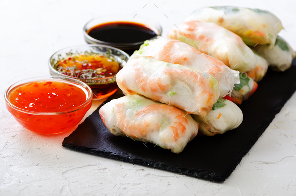 Vietnamese spring rolls - rice paper, lettuce, salad, vermicelli, noodles, shrimps, fish sauce - Stock Photo - Images