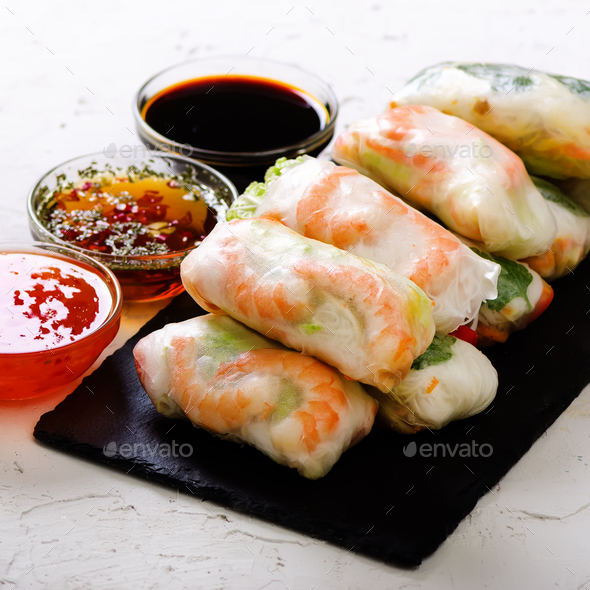 Vietnamese spring rolls - rice paper, lettuce, salad, vermicelli, noodles, shrimps, fish sauce - Stock Photo - Images