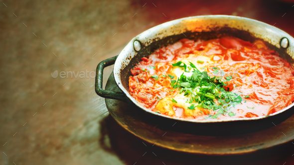 Shakshuka. Traditional jewish food and middle eastern cuisine recipe. Fried eggs, tomatoes, bell - Stock Photo - Images