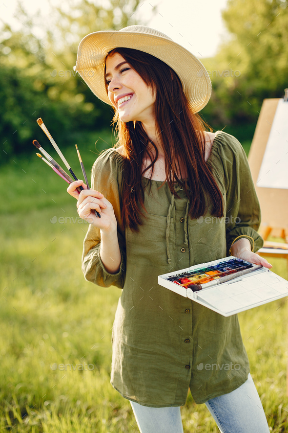 Elegant and beautiful girl painting in a field Stock Photo by prostooleh