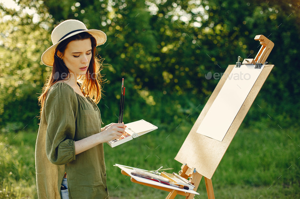 Elegant and beautiful girl painting in a field Stock Photo by prostooleh