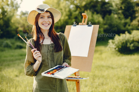 Elegant and beautiful girl painting in a field Stock Photo by prostooleh