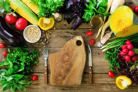 Vegetables on wooden background. Herbs, basil, onion, pumpkin, pine nuts, tomatoes, corn, radish - Stock Photo - Images