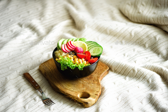 Buddha bowl with avocado, quinoa, cucumber, radish, salad, lemon, cherry tomatoes, chickpea, chia - Stock Photo - Images