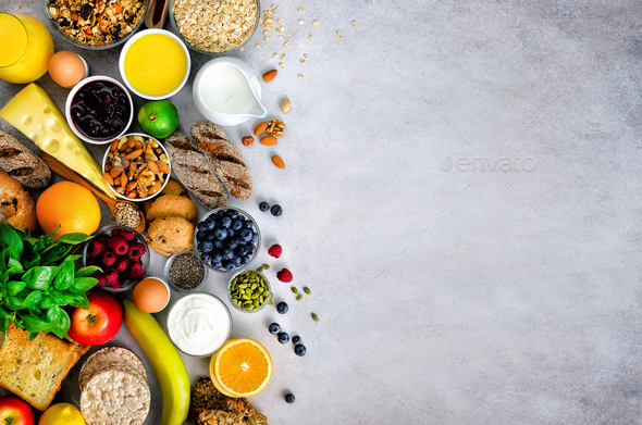 Healthy breakfast ingredients, food frame. Granola, egg, nuts, fruits, berries, toast, milk, yogurt - Stock Photo - Images