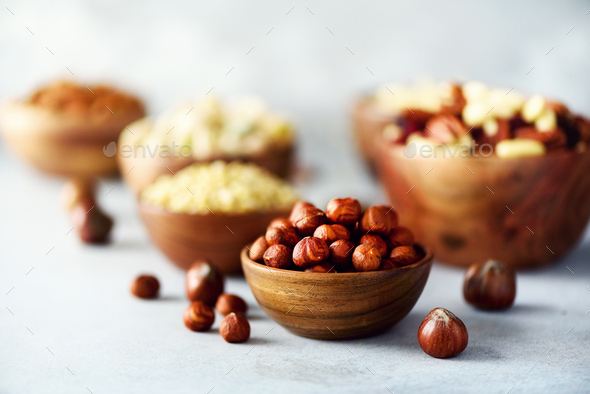 Hazelnuts in wooden bowl. Food mix background, top view, copy space, banner. Assortment of nuts - - Stock Photo - Images