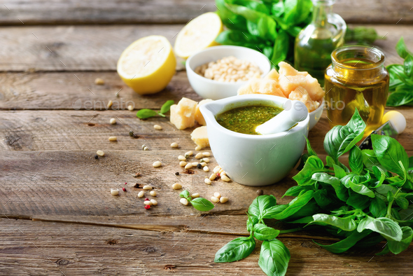 Ingredients for homemade pesto - basil, lemon, parmesan, pine nuts, garlic, olive oil and salt on - Stock Photo - Images