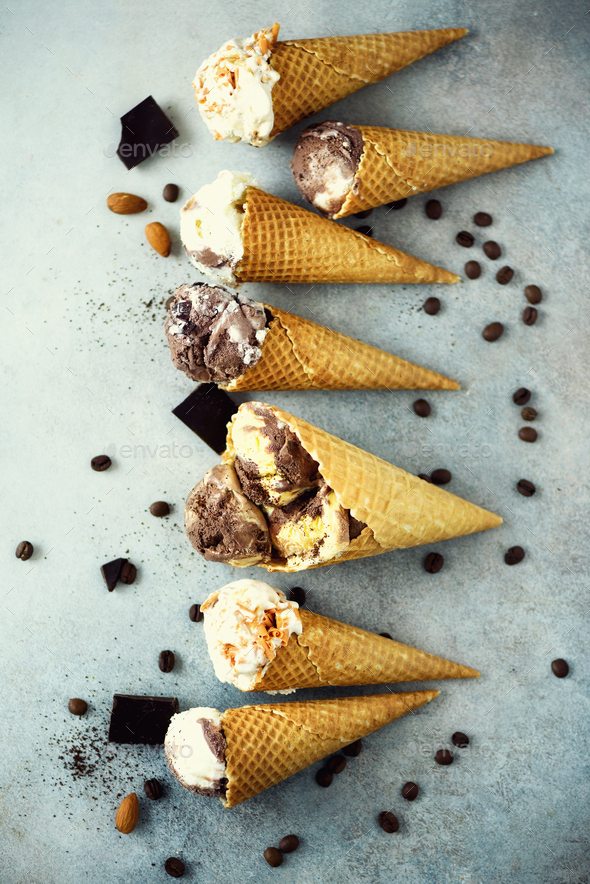 Chocolate and coffee ice cream in waffle cone with coffee beans on grey stone background. Summer - Stock Photo - Images