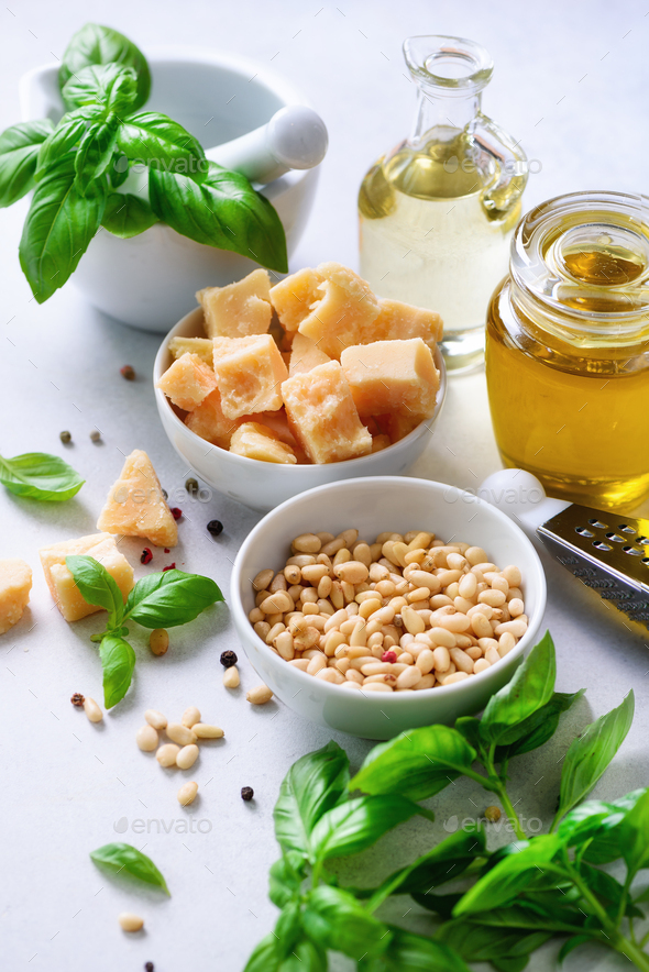 Ingredients for homemade pesto - basil, lemon, parmesan, pine nuts, garlic, olive oil and salt on - Stock Photo - Images