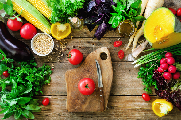 Vegetables on wooden background. Herbs, basil, onion, pumpkin, pine nuts, tomatoes, corn, radish - Stock Photo - Images