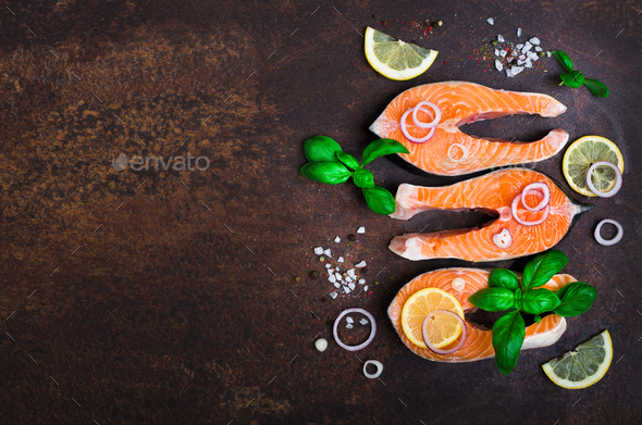 Raw fresh salmon steak with vegetables. Ingredients for cooking on brown background. Space for text - Stock Photo - Images