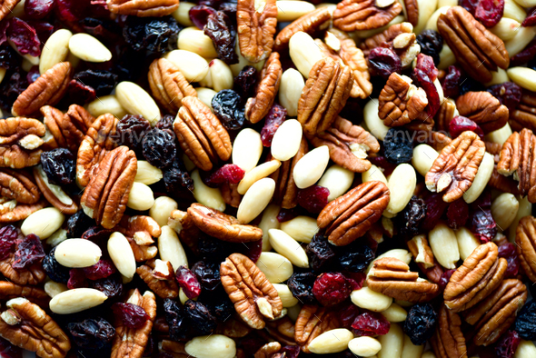 Mixed nuts and raisins in wooden bowl. Healthy food and snack. Walnut, pistachios, almonds - Stock Photo - Images