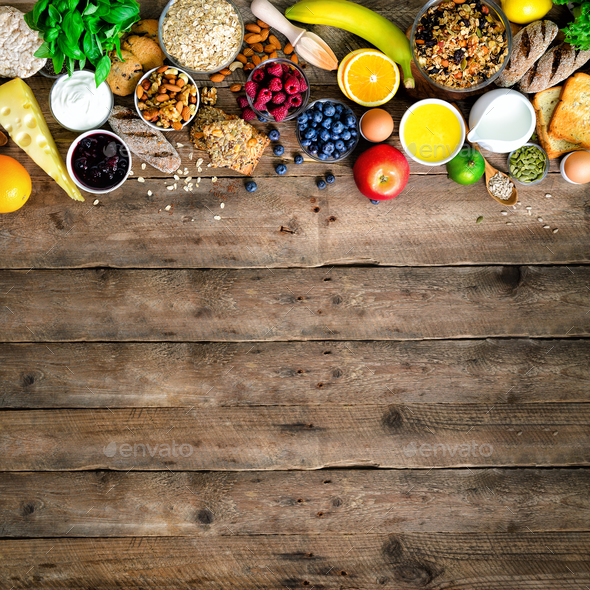 Healthy breakfast ingredients, food frame. Granola, egg, nuts, fruits, berries, toast, milk, yogurt - Stock Photo - Images