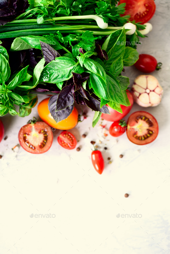 Fresh spinach,green onion, basil, herbs, dill and tomatoes on gray concrete background, selective - Stock Photo - Images